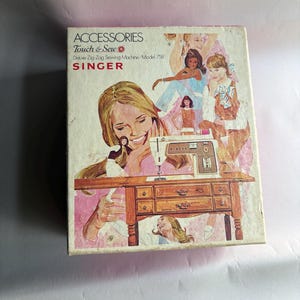 May include: Vintage Singer sewing machine accessories box. The box features illustrations of women and a sewing machine. Text on the box reads "ACCESSORIES Touch & Sew Deluxe Zig-Zag Sewing Machine/Model 758 SINGER". The box has a pink and brown color scheme.