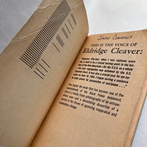 May include: A close-up of a book titled "This is the Voice of Eldridge Cleaver" by Jimmy Connolly. The book cover is a light brown color with black text. The text on the cover reads: "Nineteen fifty-four, when I was eighteen years old, is held to be a crucial turning point in the history of the Afro-American for the U.S.A. as a whole -the year segregation was outlawed by the U.S. Supreme Court. It was also a crucial year for me because on June 18, 1954, I began serving a sentence in state prison for possession of marijuana..."