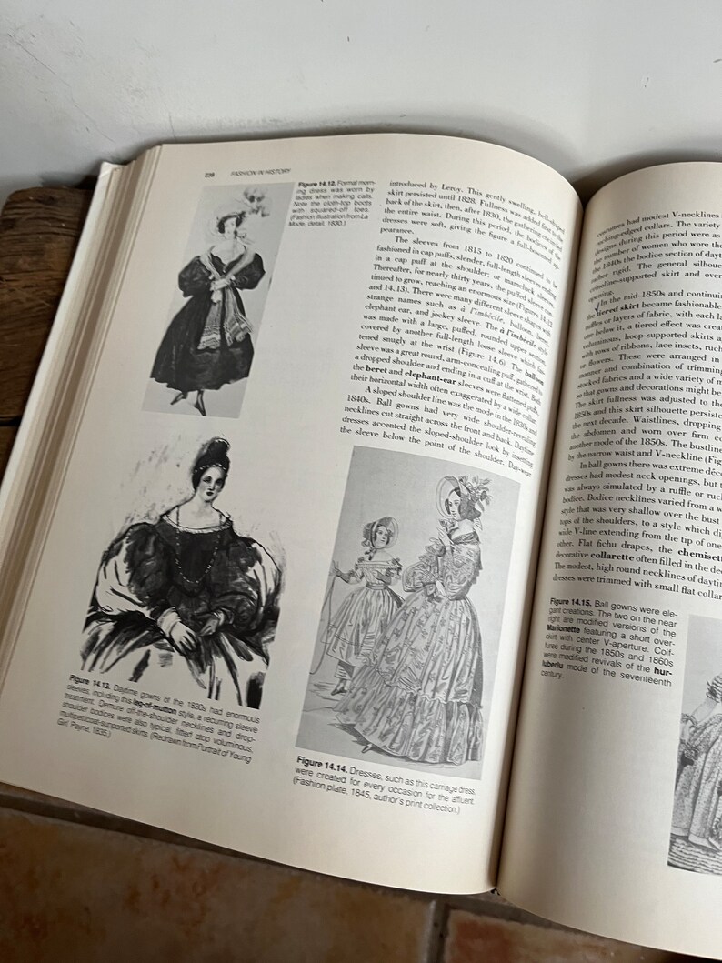 May include: A vintage fashion illustration depicting women wearing dresses from the 1840s. The dresses feature full skirts, high necklines, and puffed sleeves. The illustration is in black and white and has a detailed, intricate style.