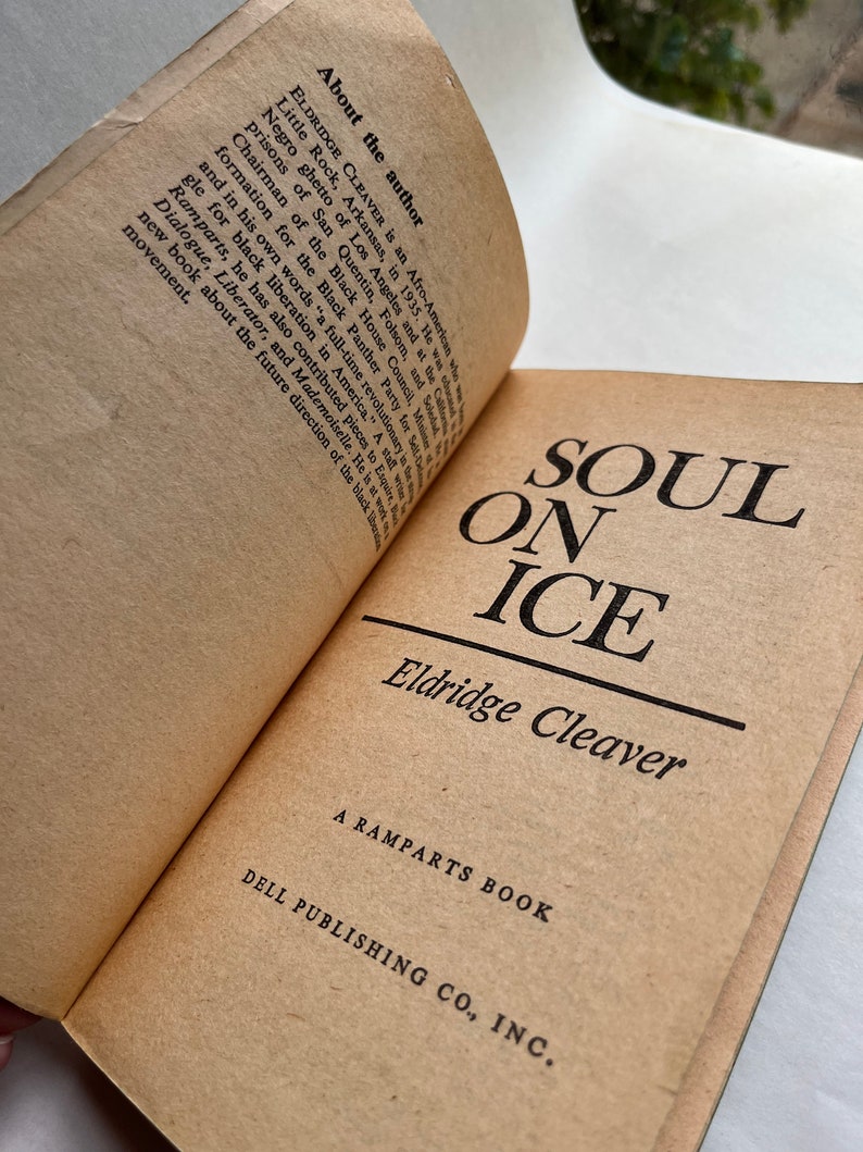 May include: A vintage paperback book titled "Soul on Ice" by Eldridge Cleaver. The book is a Ramparts Book published by Dell Publishing Co., Inc.