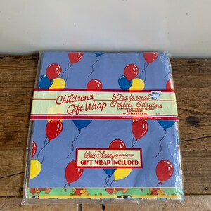 May include: A pack of 12 sheets of Children's Gift Wrap featuring 6 different designs with a total of 50 square feet of wrapping paper. The designs feature balloons and a Walt Disney character. The pack is priced at &pound;1.71.