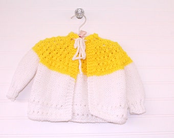 Vintage baby sweater, yellow and white knit with tie closure at top, also includes bonnet and booties. No name size 3-6 months