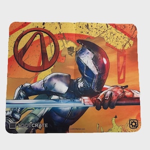 May include: A rectangular microfiber cloth featuring a graphic illustration of a character in a dark blue and silver helmet holding a long blade. The background is orange and yellow with a red circular logo and the text Loot Crate in the corner.
