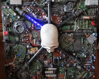 May include: A white skull sculpture is the centerpiece of this artwork, surrounded by a variety of electronic components, including circuit boards, wires, and resistors. The artwork has a dark, industrial aesthetic and is reminiscent of a cyberpunk style.
