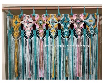 May include: A macrame wall hanging with a geometric pattern in teal, yellow, pink, and gray. The hanging has a fringe of tassels at the bottom.