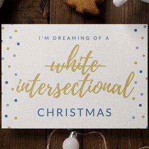 May include: A white card with gold lettering that reads "I'm dreaming of a white intersectional Christmas." The card is surrounded by brown paper gift wrap, a cup of coffee, and a gingerbread cookie.