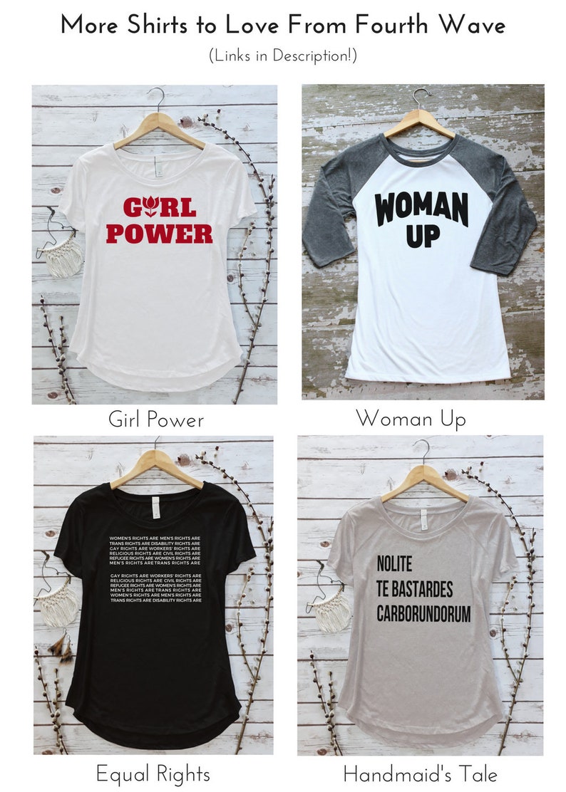 May include: Four different t-shirt designs with various slogans. The first shirt is white with red text that says "Girl Power". The second shirt is white with a gray sleeve and black text that says "Woman Up". The third shirt is black with white text that says "Women's Rights are Men's Rights are Trans Rights are Disability Rights are Gay Rights are Workers Rights are Religious Rights are Civil Rights are Refugee Rights are Women's Rights are Men's Rights are Trans Rights are". The fourth shirt is gray with black text that says "Nolite Te Bastardes Carborundorum".