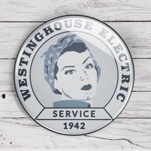 May include: A white and blue round button with the text "Westinghouse Electric Service 1942". The button features a stylized image of a woman with a blue and white polka dot headscarf.