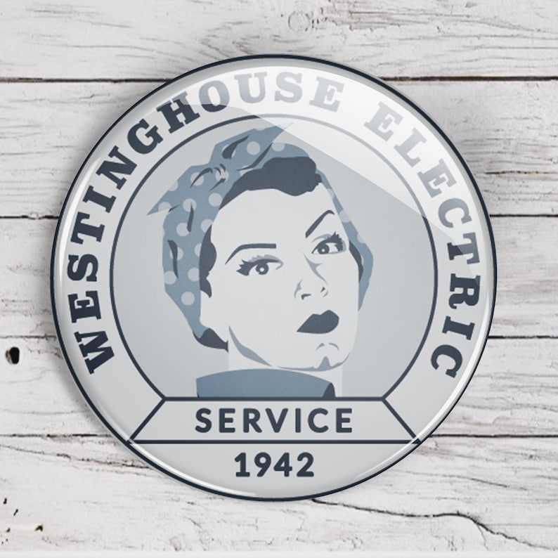 May include: A white and blue round button with the text "Westinghouse Electric Service 1942". The button features a stylized image of a woman with a blue and white polka dot headscarf.