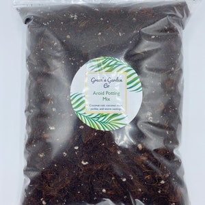 May include: A clear plastic bag filled with a dark brown potting mix. The bag has a white label with the text "Grace's Garden Co Aroid Potting Mix Coconut coir, coconut chips, perlite, and worm castings."