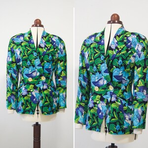 May include: A double-breasted blazer with a vibrant floral print featuring blue, green, and white flowers on a black background.