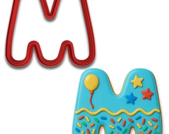 May include: A red plastic letter "M" cookie cutter next to a decorated cookie in the shape of the letter "M". The cookie is decorated with blue icing, a yellow balloon, and colorful sprinkles.