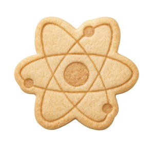 May include: A light brown sugar cookie shaped like an atom model. The cookie has a detailed design of lines and circles, with a central circle and smaller circles around the perimeter. The cookie is on a white background.