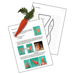 May include: Instructions for making a felt carrot craft. The instructions include a diagram of the carrot pattern and steps for sewing the carrot together. The image also shows a felt carrot with green leaves.