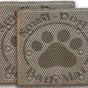 May include: Two beige, textured mats with a woven pattern and circular, button-like accents. The mats have a rectangular shape with rounded corners and a dotted border. The overall design is symmetrical and clean.