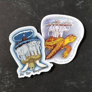May include: Two stickers with illustrations of turtles carrying the world on their backs. The first sticker shows a turtle carrying three elephants, with the text "In the Beginning..." The second sticker shows a turtle carrying four elephants, with the text "Can I just move to this world already please."