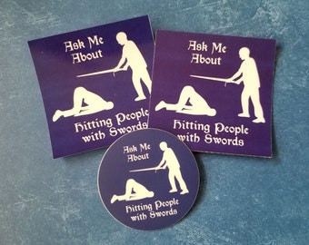 HEMA "Ask Me About Hitting People with Swords" stickers and magnets