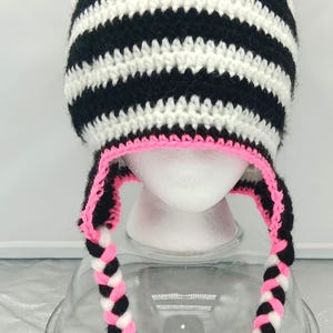 May include: A set of three ceramic nesting bowls in graduating sizes. The bowls are white with a speckled, textured finish and a slightly flared rim. The largest bowl measures approximately 8 inches in diameter.