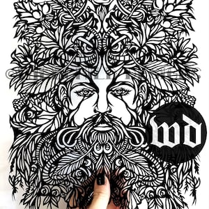 May include: Black and white paper cut art depicting a face with a beard and a crown of leaves and flowers. The art is signed "WD" in the bottom right corner and "Wildchild Designs" in the bottom left corner.