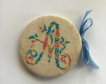 Cross stitched needle case needle book with monogram letter “A”. Monogram letter A