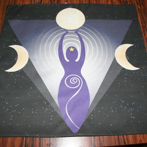 May include: A purple silhouette of a woman with a star on her forehead, holding up a full moon. The woman is surrounded by three crescent moons and a swirling pattern. The background is a dark blue with white stars.