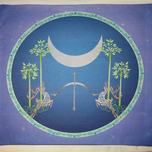 May include: A blue and green circular design with a crescent moon, two stylized trees, and two deer with antlers. The design is surrounded by a decorative border.