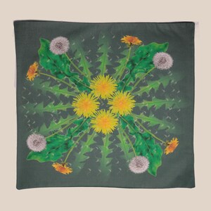 May include: A green pillow with a mandala design featuring yellow and white dandelions. The design is symmetrical and features a repeating pattern of dandelions in various stages of bloom.