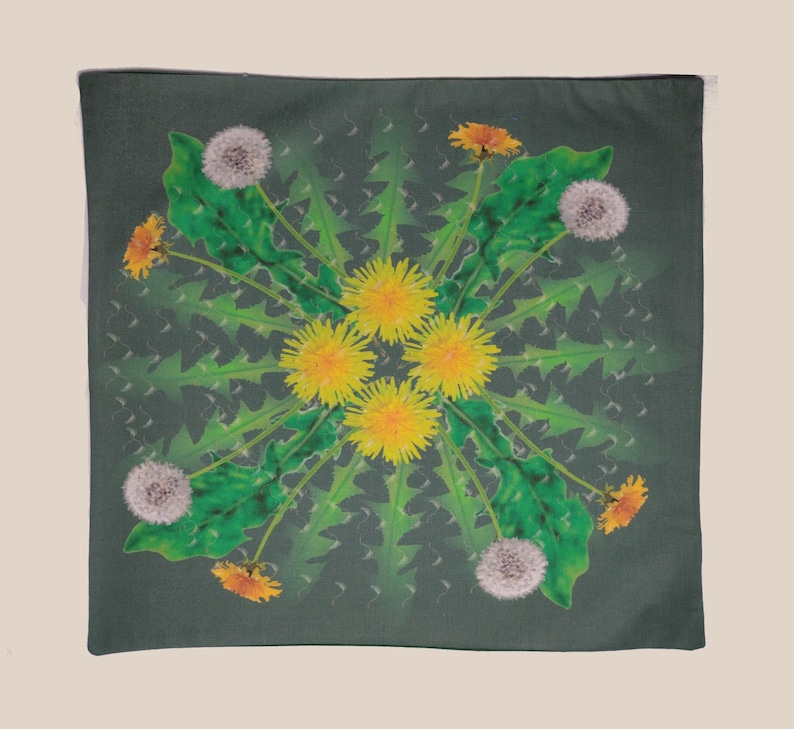May include: A green pillow with a mandala design featuring yellow and white dandelions. The design is symmetrical and features a repeating pattern of dandelions in various stages of bloom.