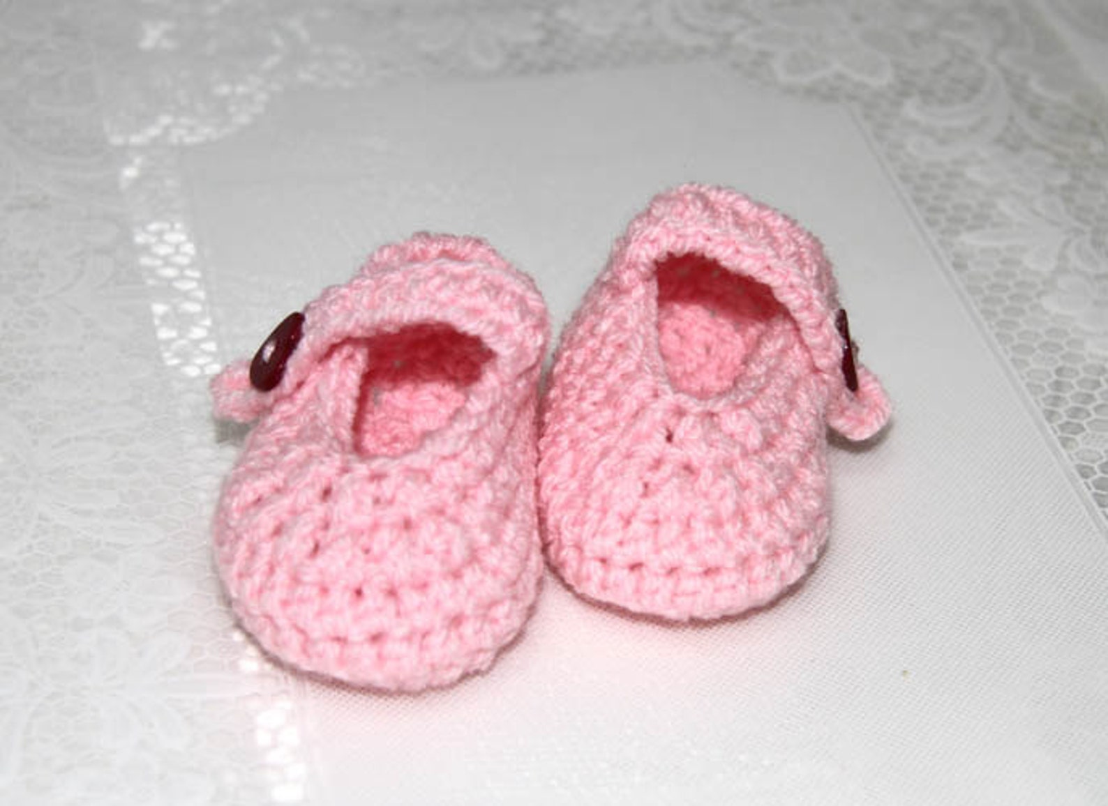 pink baby ballets shoes with heart shaped buttons