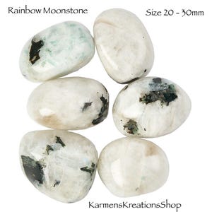 May include: Six polished Rainbow Moonstone gemstones, size 20-30mm, are displayed against a white background. The stones are oval-shaped, with a pearly white base color and dark, mossy inclusions. The text "Rainbow Moonstone" and "Size 20 - 30mm" are visible.