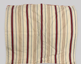 May include: A rectangular fabric textile featuring a vertical striped pattern in shades of cream, deep red, navy blue, and thin tan lines. The fabric has a smooth, woven appearance with consistent vertical alignment across the entire surface area.