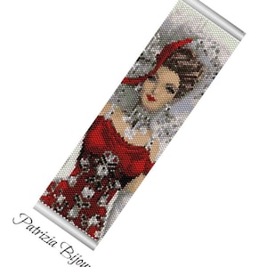 May include: A beaded bracelet featuring a portrait of a woman in a red dress and a matching headscarf. The design incorporates red, white, and black beads, with the text "Patrizia Bijoux" in cursive.
