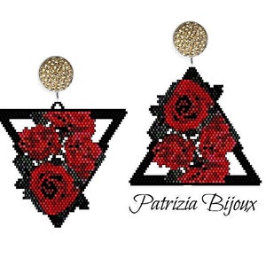 May include: A pair of earrings featuring a black triangle with red roses inside. The earrings have gold-toned tops.