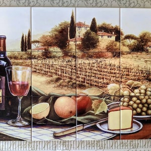 May include: A tile mural depicting a vineyard scene with a bottle of red wine, a glass of wine, grapes, fruit, and a slice of cheese. The scene is set in a rustic Italian countryside with a farmhouse in the background.