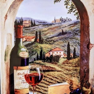 May include: A painting depicting a wine scene. A wine bottle and a glass of red wine are in the foreground, with a cheese wedge and grapes. The background shows a Tuscan landscape with rolling hills, houses, and cypress trees, framed by an arch.