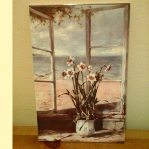 May include: A painting depicting a window with a view of the sea and a bunch of white daffodils in a vase on a windowsill.