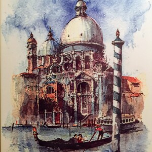 May include: A watercolor painting of a large, white church with a dome in Venice, Italy. A gondola with three people is in the foreground, and a striped pole is in the water.