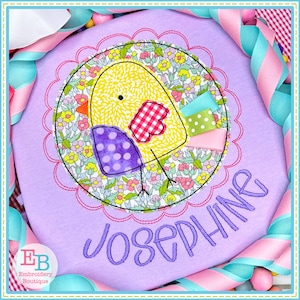 May include: A purple embroidered shirt featuring a yellow chick applique surrounded by a floral design. The name Josephine is embroidered in purple below the chick.