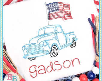 May include: Embroidered design of a blue pickup truck with an American flag on the back. The name "Gadsden" is embroidered below the truck in red thread.