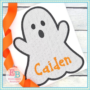 May include: A white t-shirt with a black and white ghost design and the name "Caiden" in orange text.
