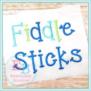 May include: Embroidered design of the words "Fiddle Sticks" in blue, green, and light blue thread on a white fabric background.