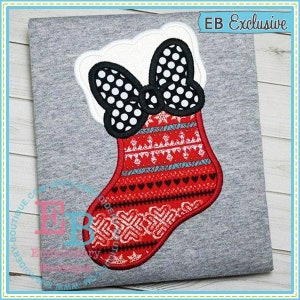 May include: Red and white Christmas stocking with a black and white polka dot bow. The stocking has a white fluffy cuff and a snowflake pattern. The text "EB Exclusive" is in the upper right corner of the image.