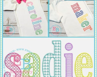 May include: A set of three embroidered designs for a baby onesie. The designs are "Caroline", "Maker", and "Sadie". The letters are outlined in different colors and filled with a checkered pattern.