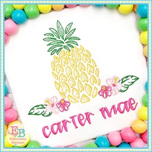 May include: Embroidered design of a yellow pineapple with green leaves and pink flowers, with the name "carter mae" stitched in pink below.