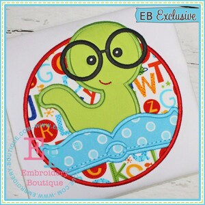 May include: A green monster wearing glasses and a blue swim cap with white polka dots. The monster is surrounded by a red circle with a colorful alphabet pattern inside.