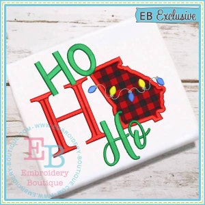May include: Embroidered design featuring the words "Ho Ho" in green and red, with a red and black plaid outline of the state of Georgia. The design includes a string of Christmas lights.