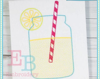 May include: A yellow and blue embroidered design of a mason jar filled with lemonade and a red and white striped straw. A yellow lemon slice is on top of the jar.