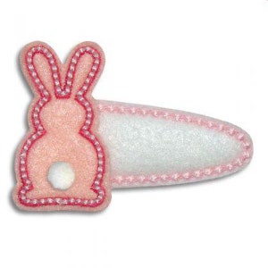 May include: Pink felt bunny hair clip with a white pom-pom tail. The bunny is outlined in pink thread.