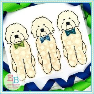 May include: Three white doodle dogs with brown eyes and black noses wearing bow ties. The dogs are standing in a row and have a checkered pattern on their bodies. The bow ties are green, blue, and teal.
