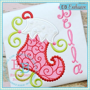 May include: Embroidered design of a pink and red stocking with a white pom-pom on top. The stocking is decorated with a swirl pattern. The word "Bella" is embroidered in pink to the right of the stocking. The text "EB Exclusive" is in the top right corner of the image.